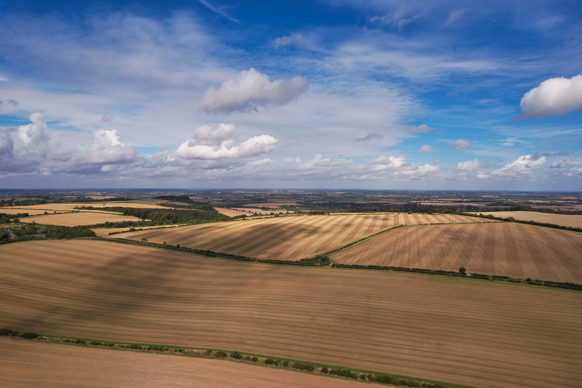 Drone aerial showing open land listing with road frontage and natural features